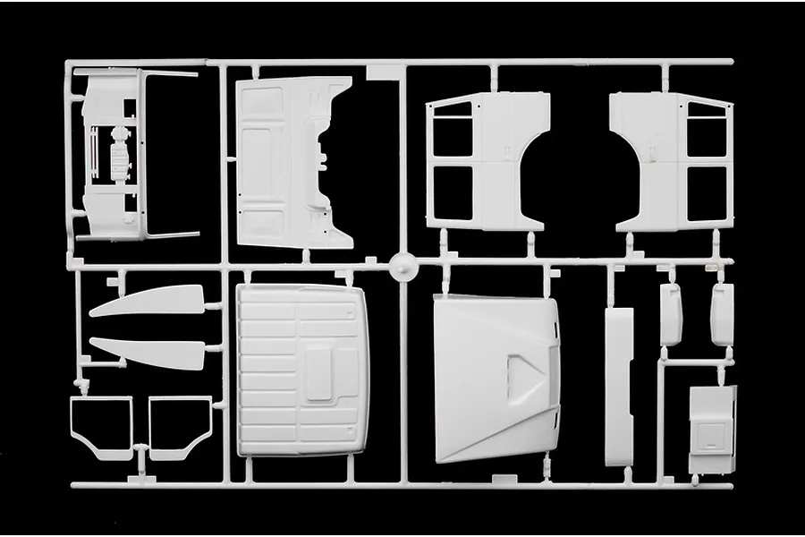 A white plastic model kit sprue containing various truck cabin parts for an Italeri 1/24 scale model.