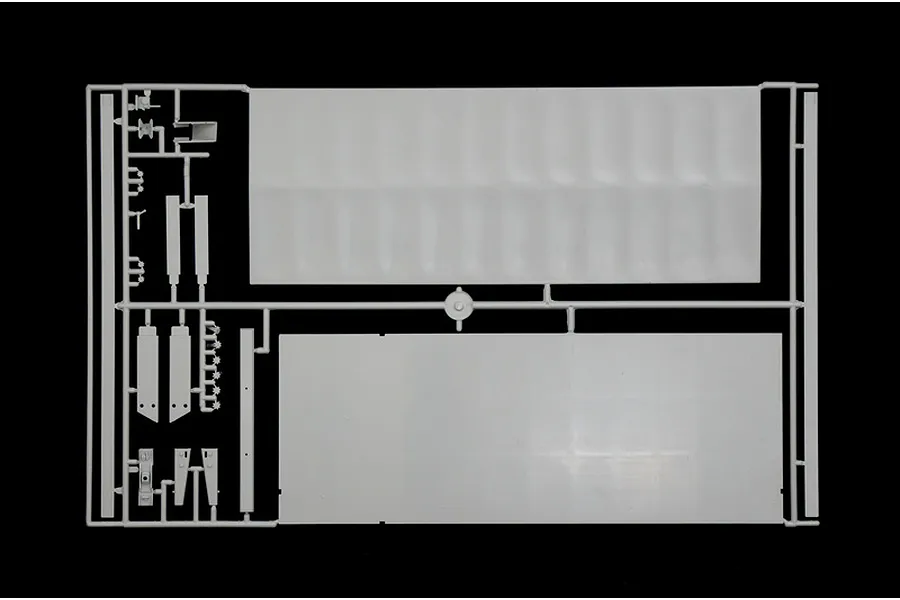 A grey plastic sprue from an Italeri 1/24 scale model truck kit, featuring large flat panels and smaller structural components.