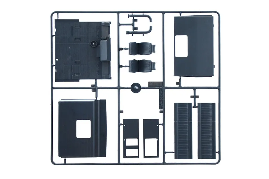 A grey plastic sprue containing various truck model parts, including seats, floor panels, and cab components for an Italeri 1/24 Scania model kit.