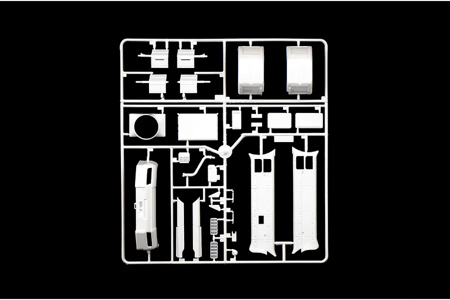 A white plastic sprue containing various unpainted model truck parts for an Italeri 1/24 scale Scania Y143H model kit.