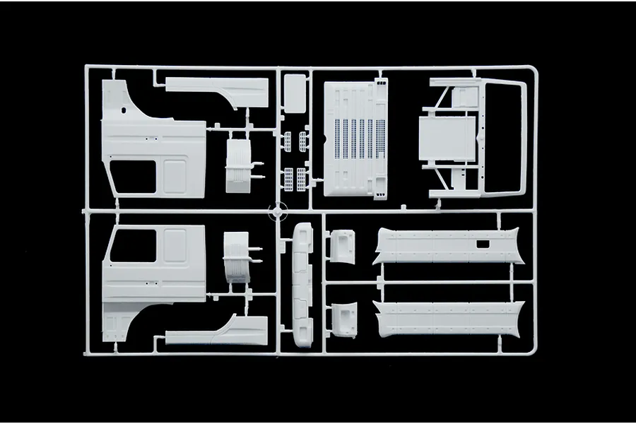 A white plastic model kit sprue containing various truck cab and body parts for a 1/24 scale Scania model truck.