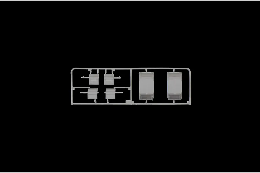 A grey plastic model kit sprue containing four small rectangular parts and two larger curved parts against a black background.