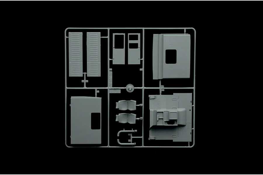 A grey plastic sprue containing various model truck parts including doors, seats, and interior panels for an Italeri 1/24 scale Scania model kit.