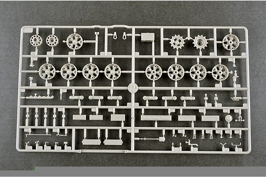 A grey plastic model kit sprue containing various tank wheels, sprockets, and small mechanical components for a 1/35 scale military model.