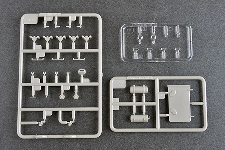 Three plastic model kit sprues from the Trumpeter 1/35 Soviet BTR-152K1 APC kit, including grey and clear plastic parts on a dark grey surface.