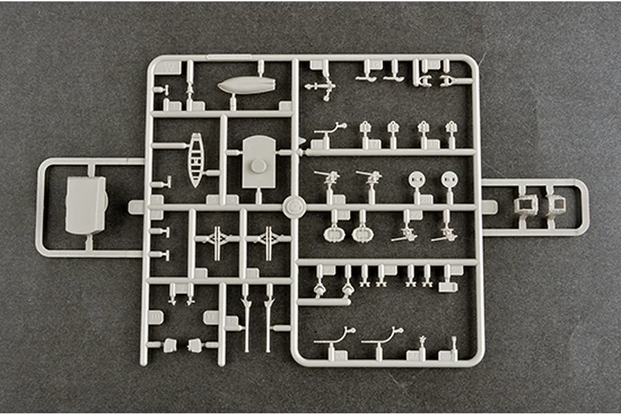 A grey plastic sprue containing various small model parts for a 1/350 scale ship kit, including lifeboats, guns, and structural components.