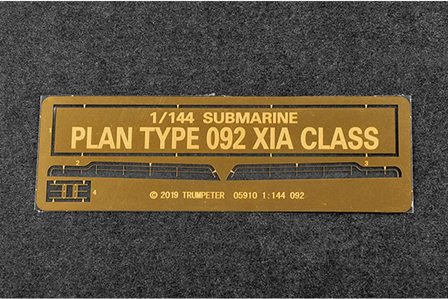 A brass photo-etched detail sheet for a 1/144 scale Trumpeter Type 092 Xia Class submarine model kit, featuring railings and small parts.