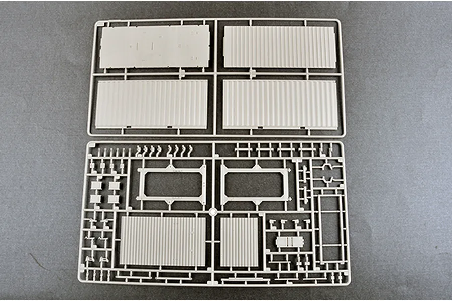Two light grey plastic model kit sprues containing various flat panels and structural components for a 1/35 scale model.