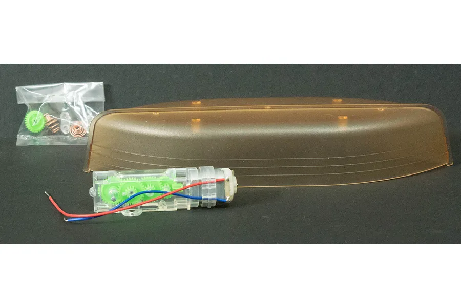 Academy Kayak Robot model kit components including a translucent brown hull, a clear gear motor assembly with green gears, and a small bag of hardware.