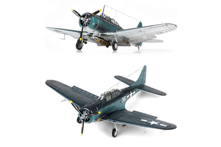 Two views of a fully assembled and painted 1/48 scale Academy SBD-5 Dauntless model aircraft, showing the dark blue camouflage and US Navy markings.