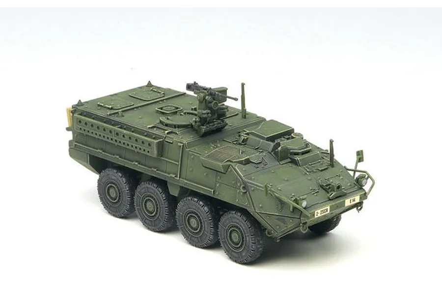 A 1/72 scale plastic model of a green Stryker armoured personnel carrier on a white background.