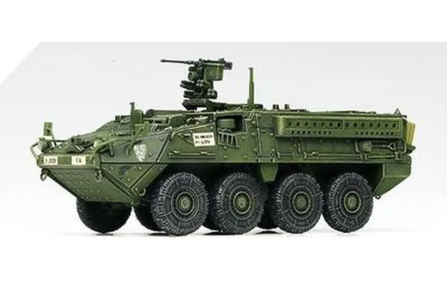 A side-profile view of a completed and painted 1/72 scale Academy Stryker armoured personnel carrier model kit on a white background.