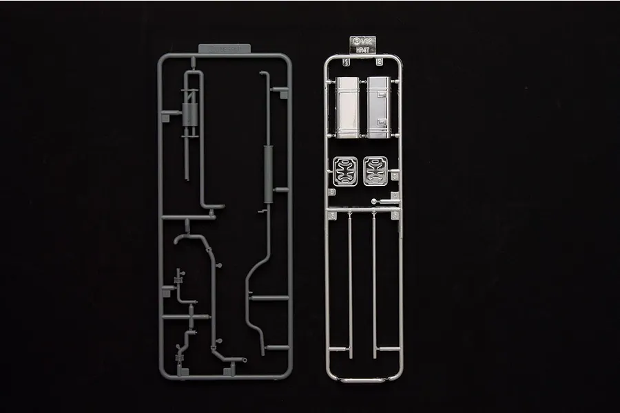 Two plastic model kit sprues for a 1/32 scale truck accessory set by Fujimi, featuring grey and chrome-plated parts on a black background.