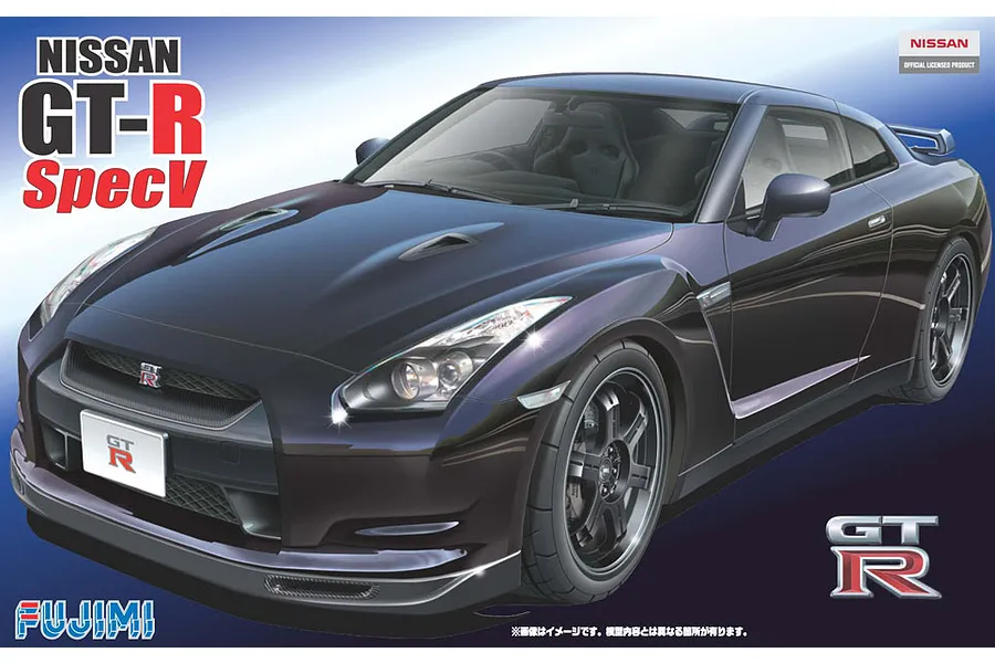 Box art for a Fujimi 1/24 scale Nissan GT-R Spec-V plastic model kit featuring a dark purple sports car against a blue gradient background.