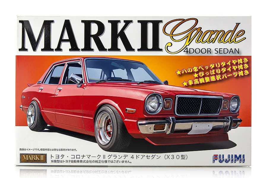 Fujimi 1/24 scale Toyota Corona Mark II Grande 4-door sedan plastic model kit box art featuring a red custom sedan.
