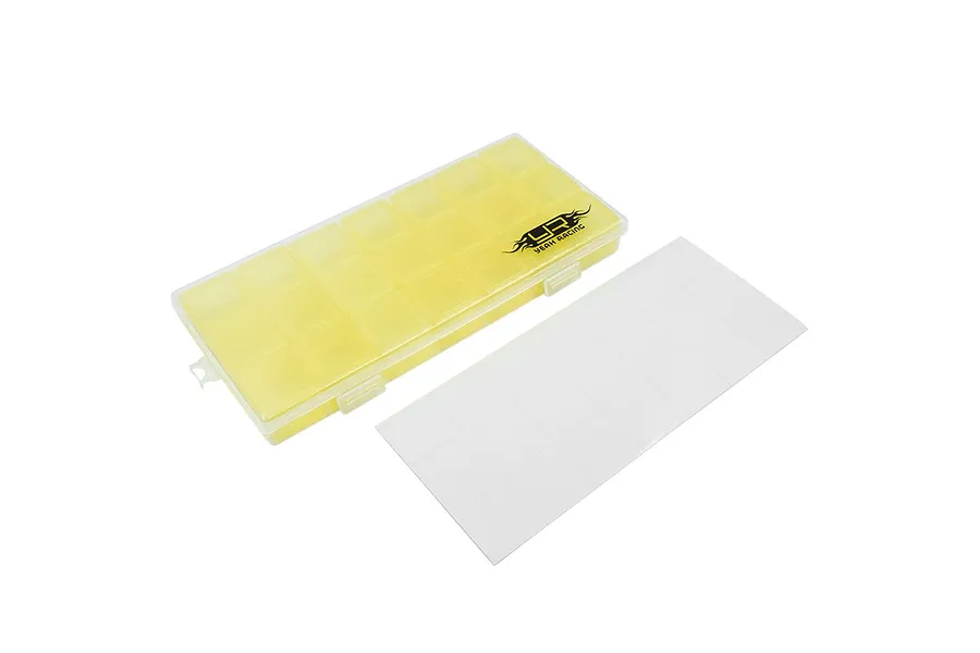 A yellow translucent plastic multi-compartment storage box by Yeah Racing with a sheet of white adhesive labels on a white background.