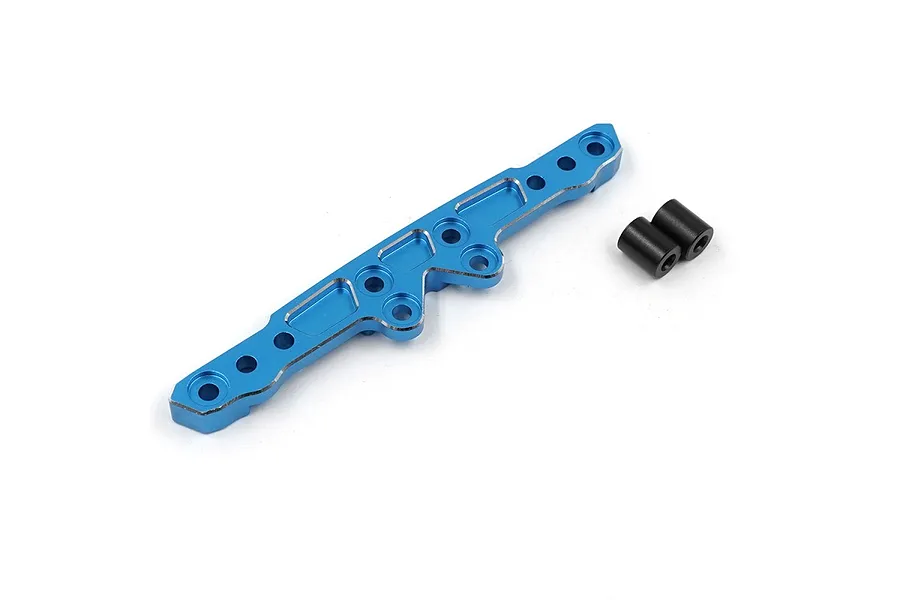 A blue anodized aluminium front damper tower for an RC car, accompanied by two small black cylindrical spacers on a white background.