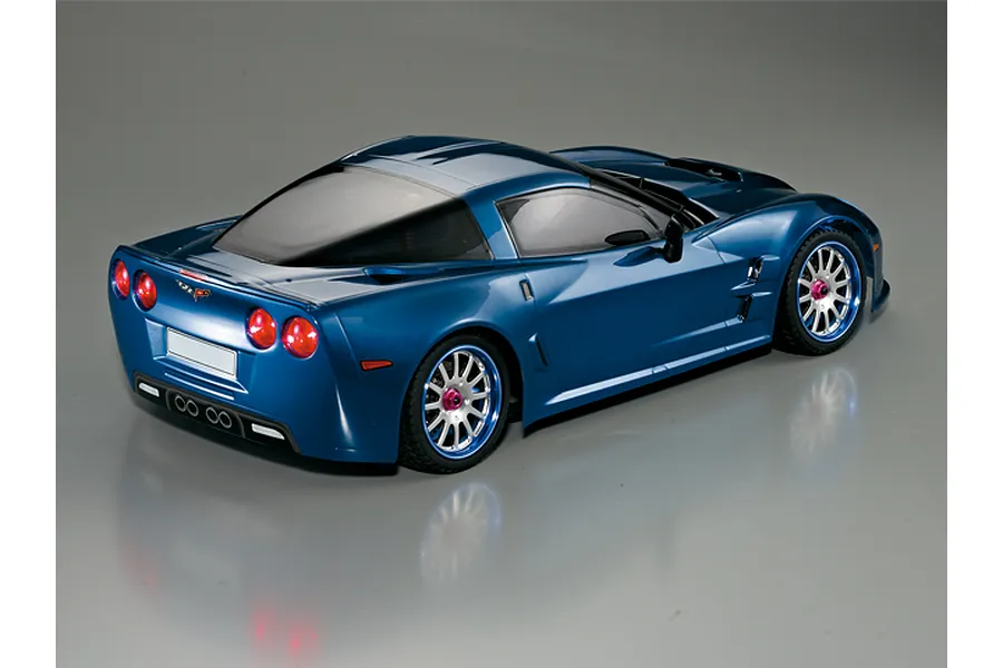 Rear three-quarter view of a metallic blue Killerbody 1/10 scale Corvette GT2 RC car body shell on a grey background.