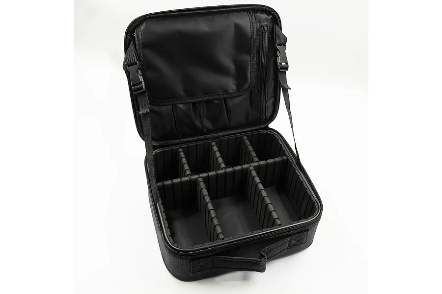 An open black Yeah Racing multi-purpose nylon hard case bag with adjustable internal foam dividers and a zippered lid pocket.