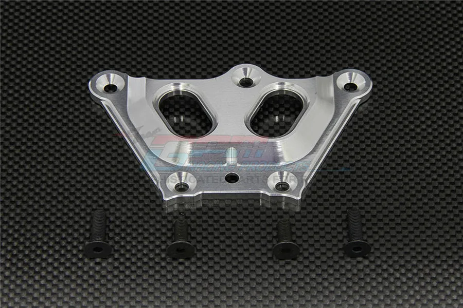 GPM Racing silver aluminium front chassis brace for RC vehicles, shown with four black mounting screws on a carbon fiber background.