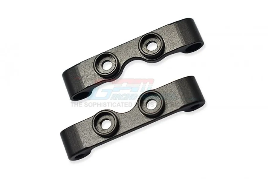 Two black aluminium suspension arm mounts for RC cars by GPM Racing, shown from a top-down perspective on a white background.