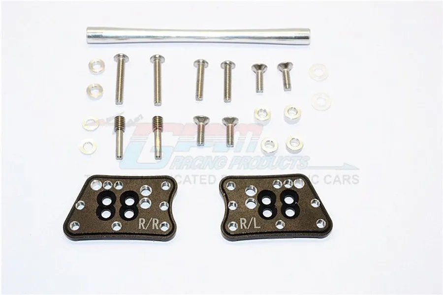 GPM Racing black aluminium rear adjustable shock mounts with mounting hardware including screws, washers, and a metal cross brace.