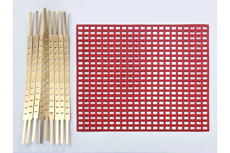 A red mesh protection curtain and several gold-coloured metal mounting strips for a 1/10 scale RC model.