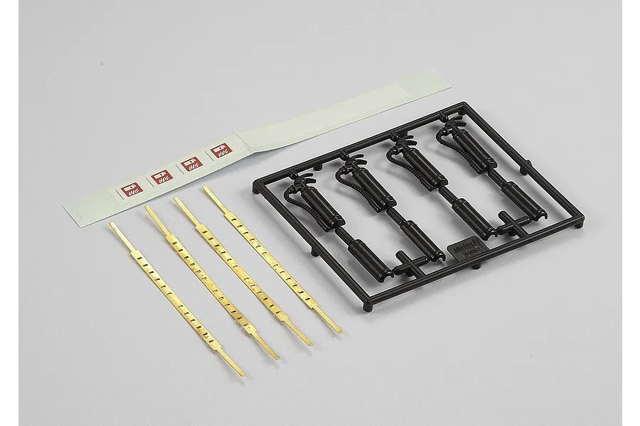 Killerbody RC fire extinguisher accessory kit including a black plastic parts tree, four brass-colored metal strips, and a sheet of fire extinguisher decals.