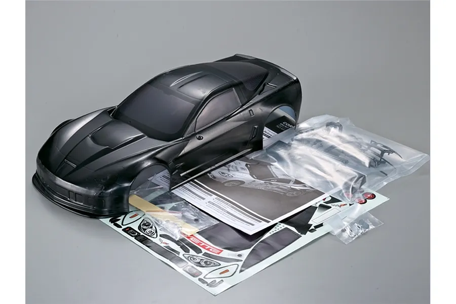Killerbody 1/10 scale black Corvette GT2 RC car body shell with included decal sheet, instruction manual, and plastic accessory parts in bags.