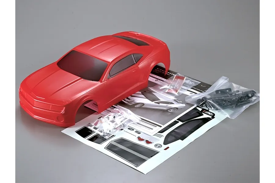 A red 1/10 scale 2011 Camaro RC body shell with included decal sheet, instruction manual, and small plastic accessory bags on a grey background.