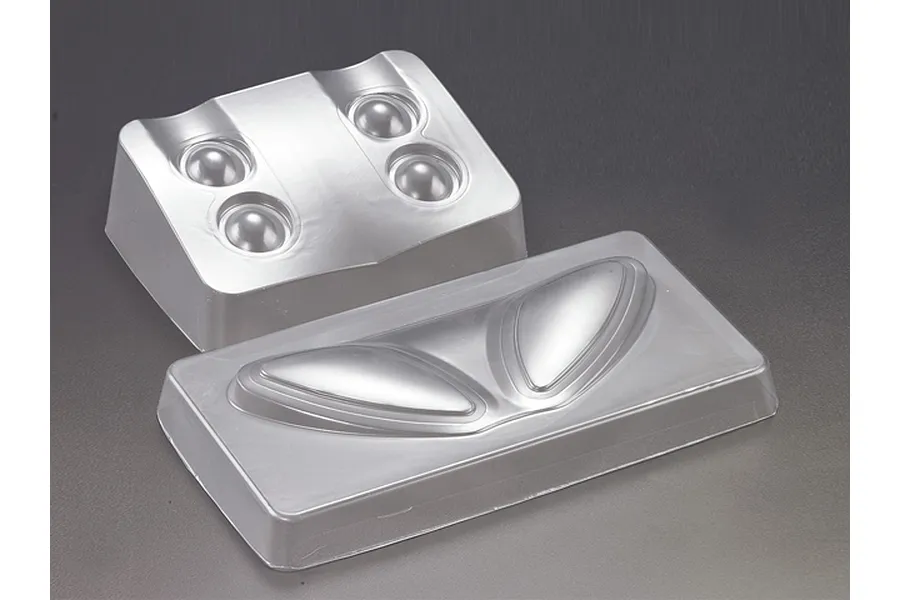Two clear, vacuum-formed plastic light bucket inserts for a 1/7 scale RC car body.