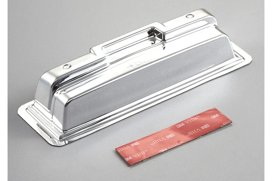 A chrome-plated RC monster truck rear bumper with a strip of 3M VHB double-sided adhesive tape.