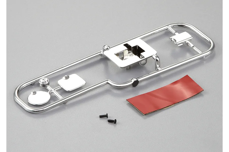 Killerbody 1/10 scale touring car fuel door accessory kit on a chrome plastic parts tree with double-sided tape and two small screws.