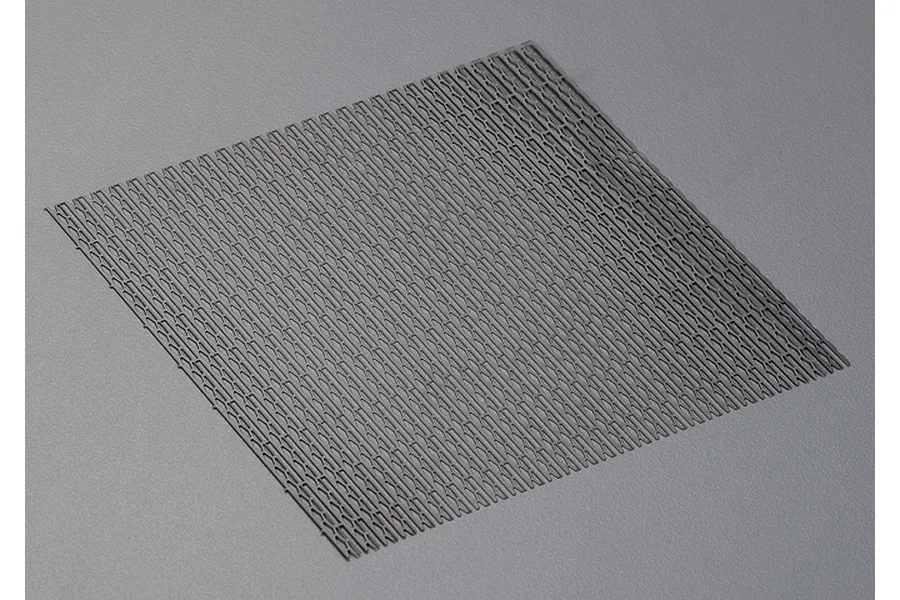 A square sheet of black stainless steel mesh with a repeating geometric pattern, designed for RC car air intake modification.