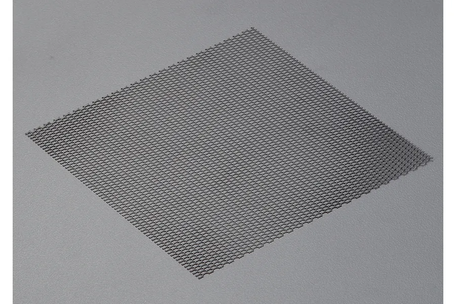 A square sheet of black stainless steel mesh with a fine hexagonal pattern, shown against a plain grey background.