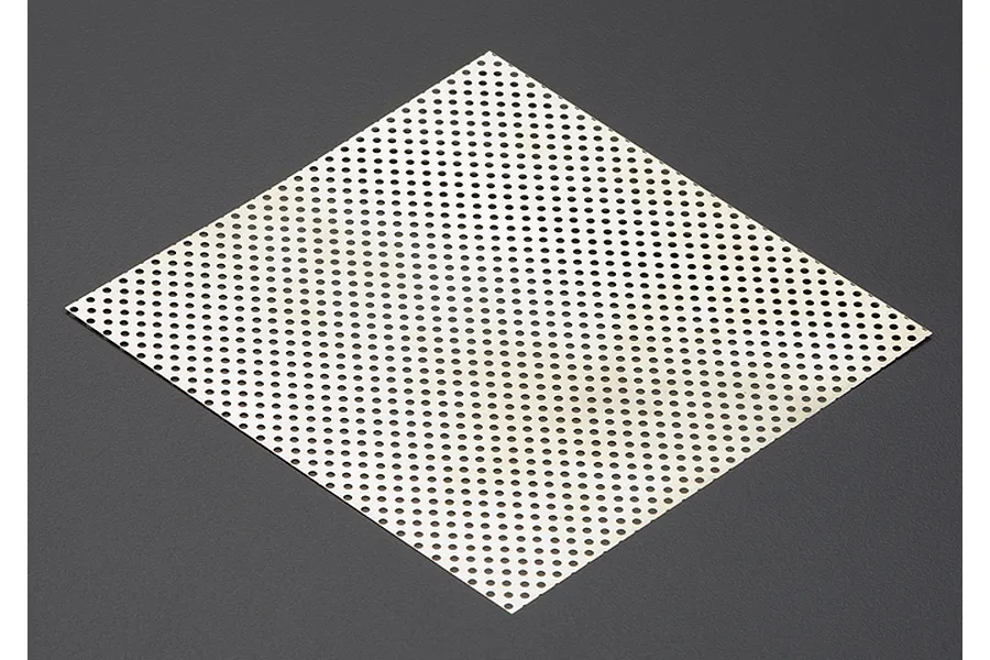 A square sheet of silver-coloured stainless steel mesh with a uniform pattern of small circular holes, set against a dark grey background.