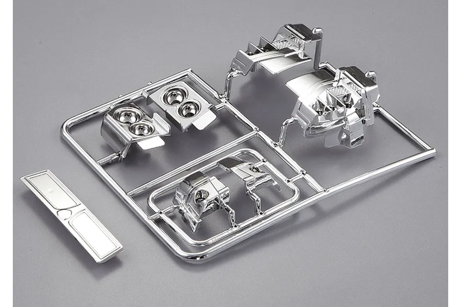 A chrome-plated plastic parts tree for a 1/10 scale Lancia Delta HF Integrale RC car body, featuring light buckets and trim pieces.