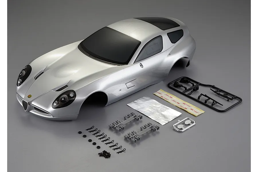 Killerbody 1/10 scale Alfa Romeo TZ3 Corsa silver painted RC car body shell with included plastic accessories, clips, and adhesive tape on a grey background.