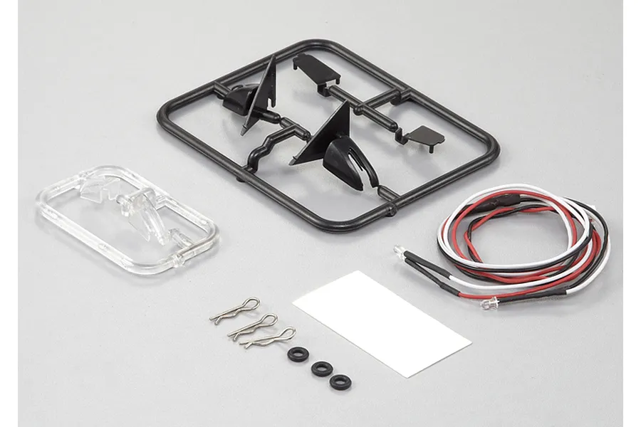 Killerbody 1/10 scale touring car wing mirror set with LED lights, plastic parts trees, body clips, and small rubber rings on a grey background.