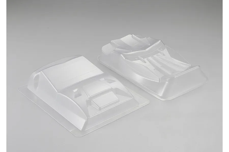 Two clear, unpainted polycarbonate RC car body modification parts set against a plain light grey background.
