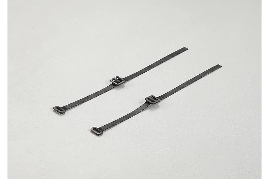 Two black fabric cable ties with plastic buckles laid out on a light grey background.
