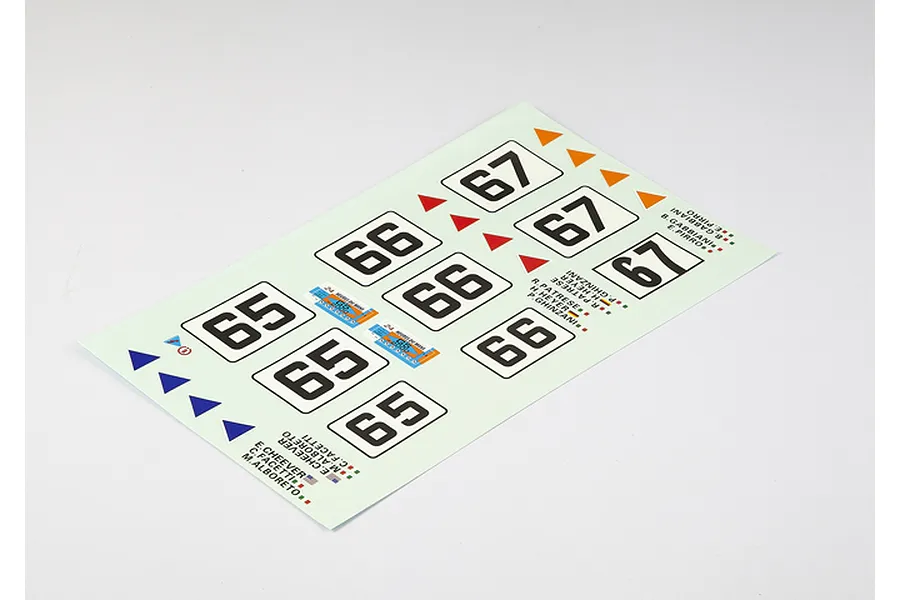 A decal sheet for an RC car featuring racing numbers 65, 66, and 67, along with driver names and small triangular markers.
