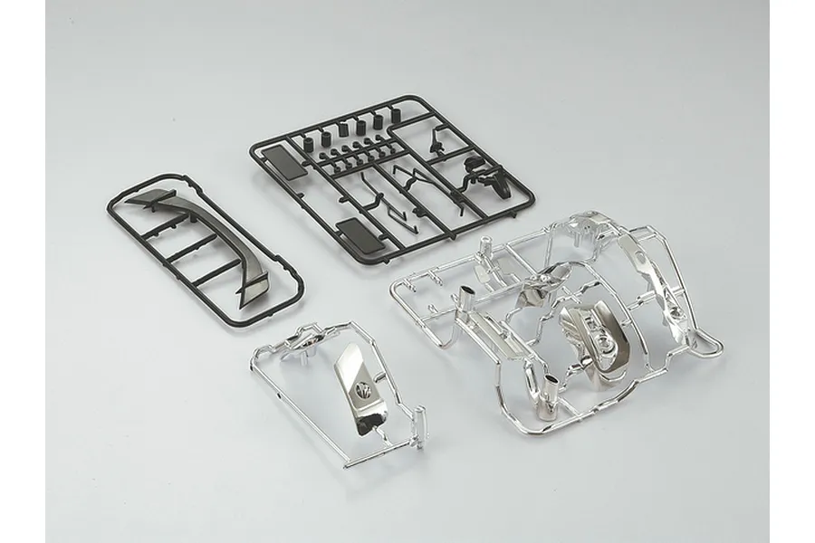 A set of unmounted plastic RC car parts for a Subaru BRZ, including black and chrome-plated sprues on a plain grey background.