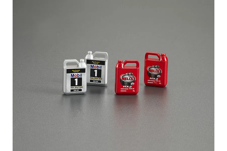Four miniature scale model oil cans, two silver Mobil 1 bottles and two red Shell Helix HX3 bottles, arranged on a grey surface.