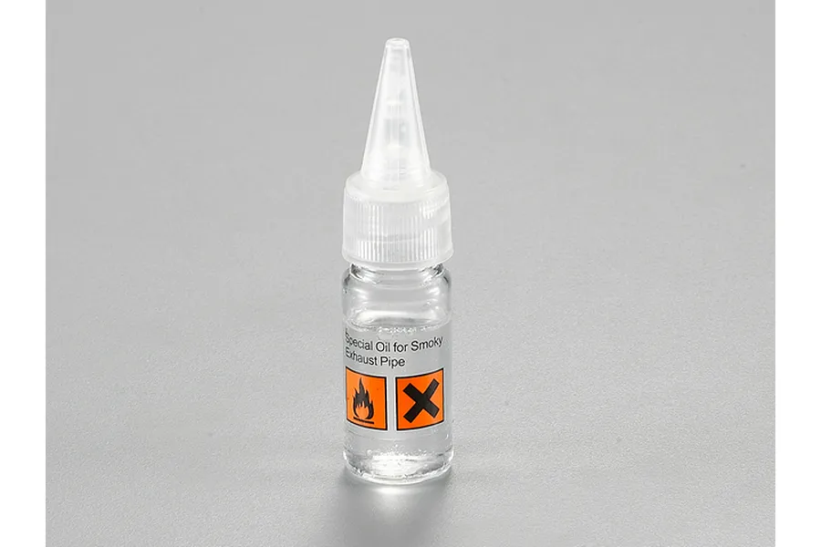 A small clear plastic bottle of Killerbody Smokey Exhaust Fuel with a pointed applicator tip and hazard warning labels on the front.