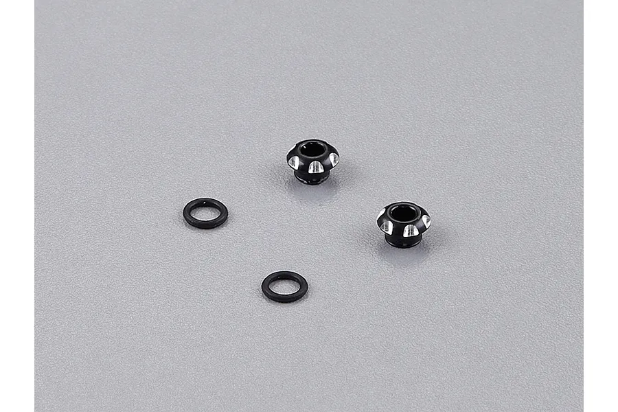 Two black aluminium LED light holders and two black rubber O-rings on a grey background.
