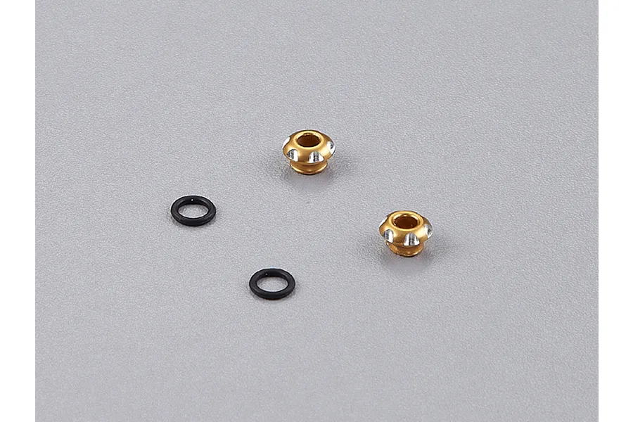 Two gold-anodized aluminium LED light holders and two black rubber O-rings on a grey background.