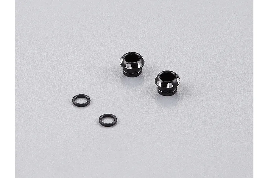 Two black aluminium 5mm LED light holders and two small black rubber O-rings on a plain grey background.