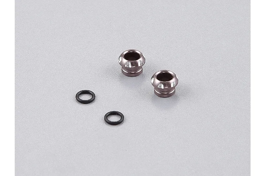 Two grey aluminium 5mm LED light holders and two small black rubber O-rings on a light grey surface.