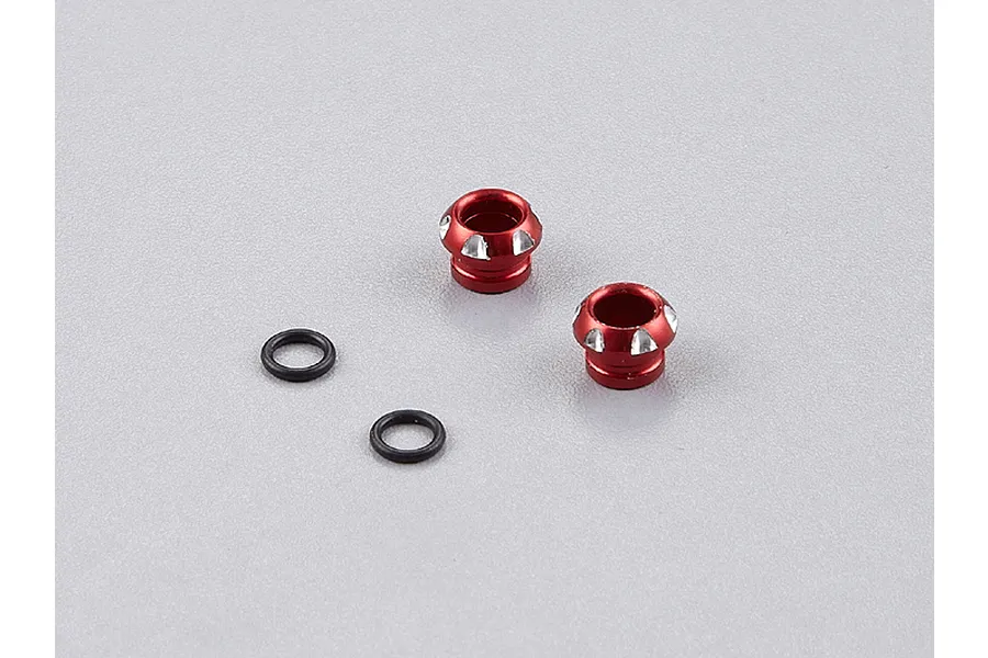 Two red aluminium LED light holders and two black rubber O-rings on a grey background.